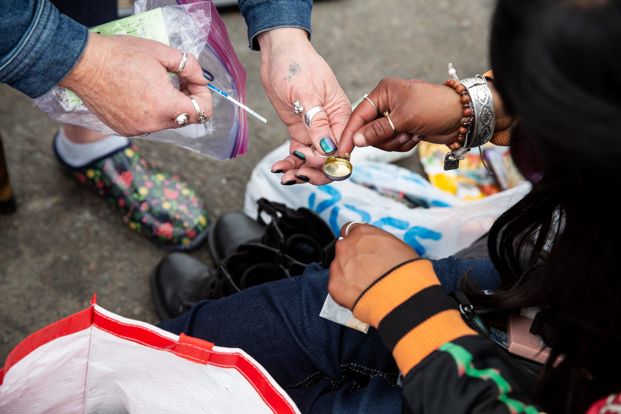 Tara Buesig, executive director of the Harm Reduction Coalition of San Diego County, uses a fentanyl test strip.