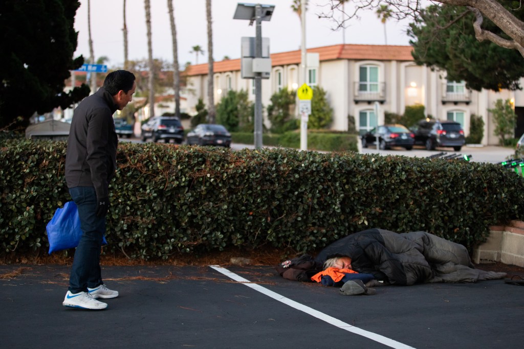 Mayor Todd Gloria approaches Steve Gordon, a homeless resident in the Ocean Beach area, while conducting the Point-in-Time Count that surveys homeless individuals throughout the San Diego region on Feb. 24, 2022. / Photo by Adriana Heldiz
