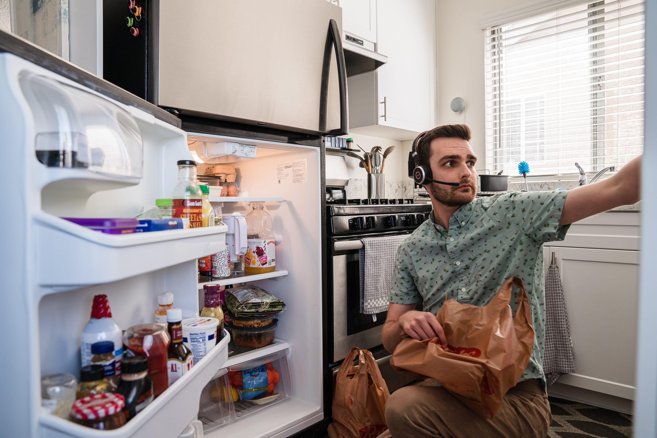 Stephen Shepherd puts his groceries away that is purchased from Instacart in University Heights on March 2, 2022.