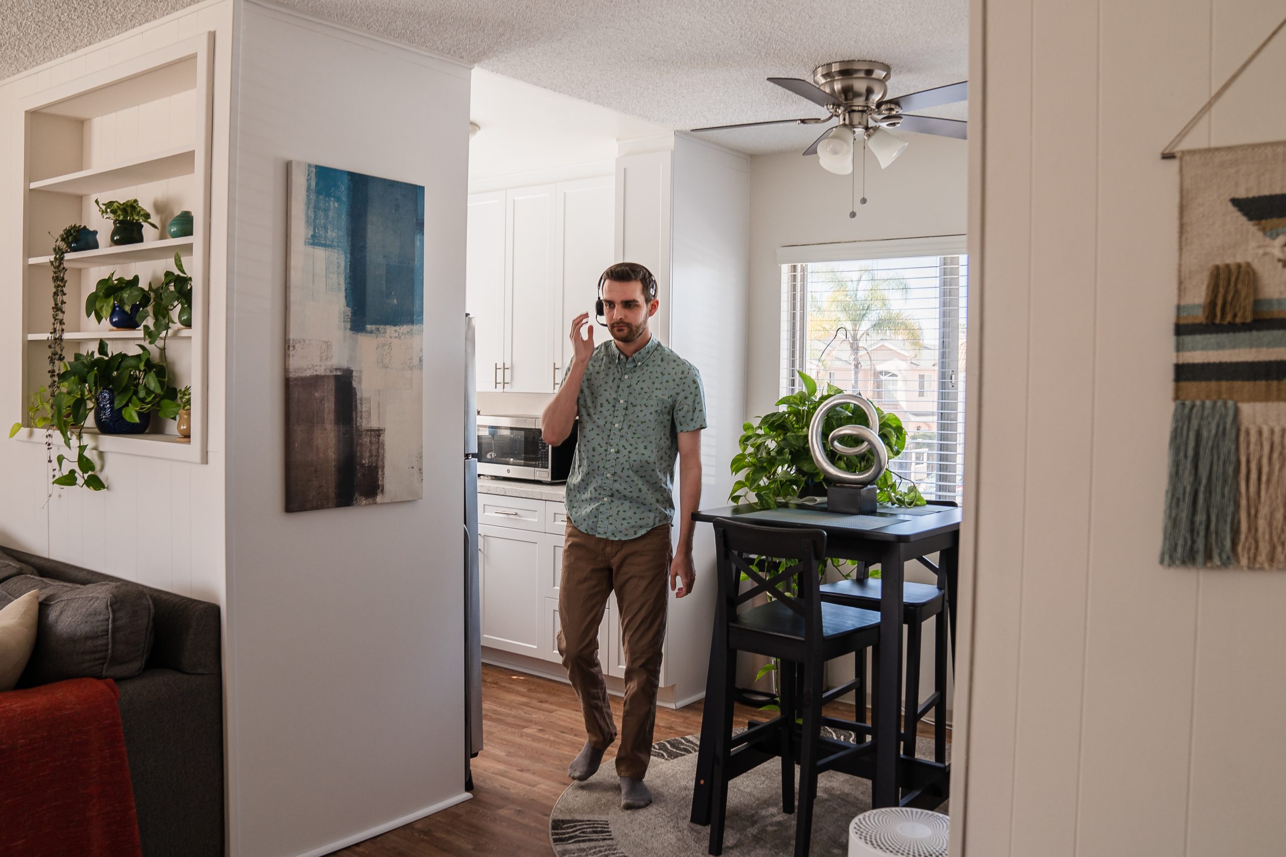 Stephen Shepherd walks back to his home office in his bedroom after putting his groceries away in University Heights on March 2, 2022.