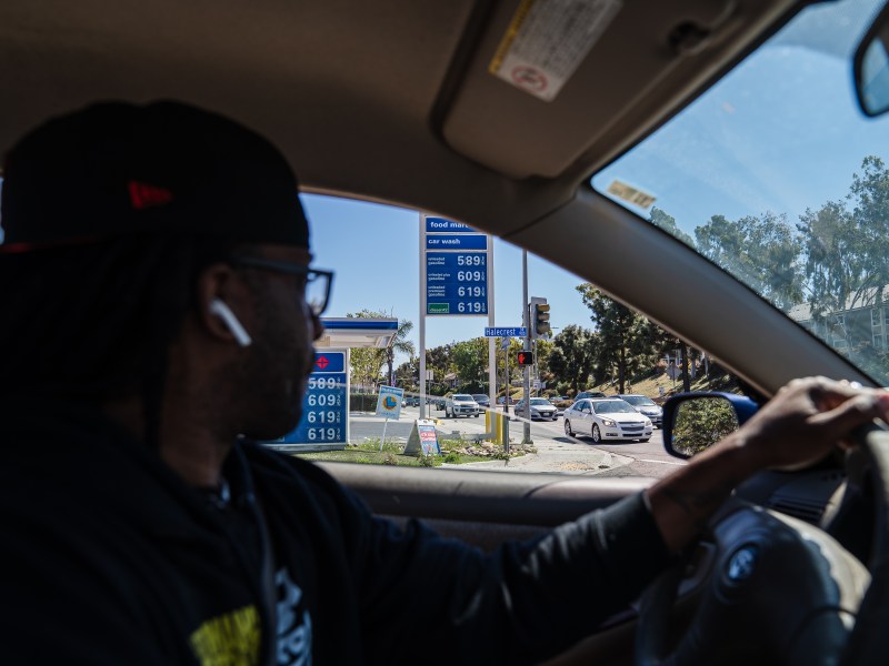 Chris LeFall passes a gas station while driving for Uber Eats in Chula Vista on March 11, 2022.
