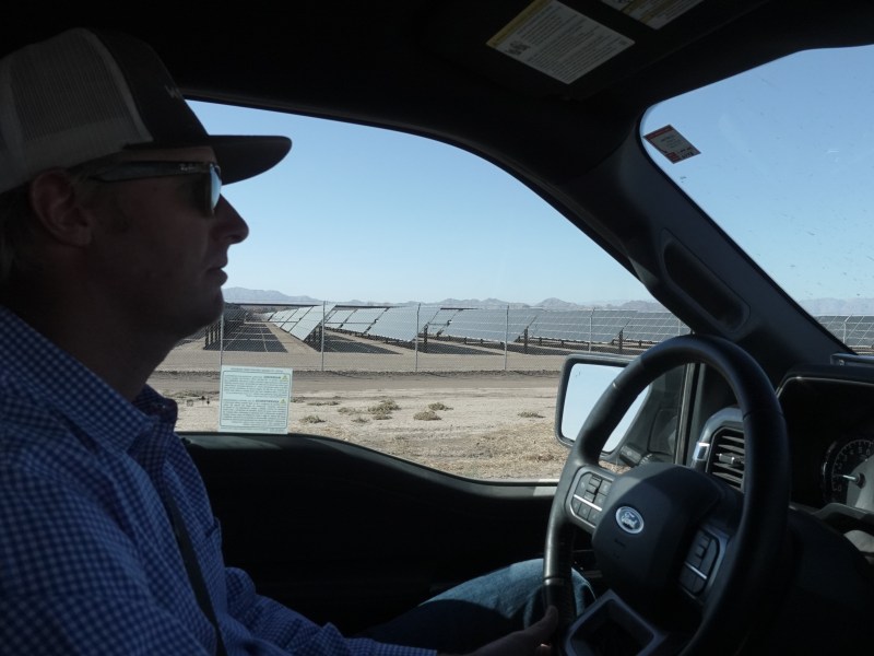 Imperial Valley farmer Trevor Tagg drives by a large solar farm near land he owns.