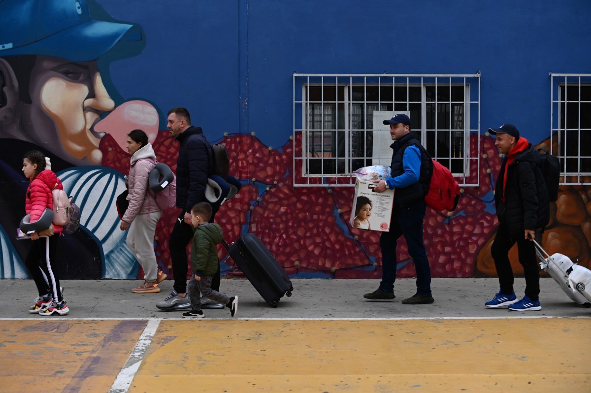 Ukrainian refugees arrive in droves to the Benito Juarez Sports Complex with hundreds seeking asylum to the United States, as the U.S. government speeds up processing to admit them under humanitarian parole. Many of these refugees are staying for a day or two in the sports complex which as been turned into a shelter in Tijuana, Mexico on Saturday, April 2, 2022. / Photo by Carlos A. Moreno for Voice of San Diego