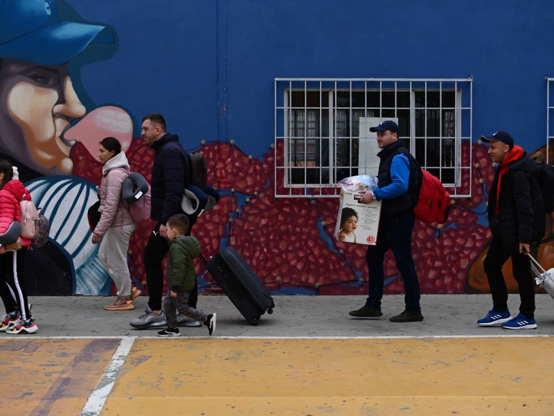 Ukrainian refugees arrive in droves to the Benito Juarez Sports Complex with hundreds seeking asylum to the United States, as the U.S. government speeds up processing to admit them under humanitarian parole. Many of these refugees are staying for a day or two in the sports complex which as been turned into a shelter in Tijuana, Mexico on Saturday, April 2, 2022. / Photo by Carlos A. Moreno for Voice of San Diego