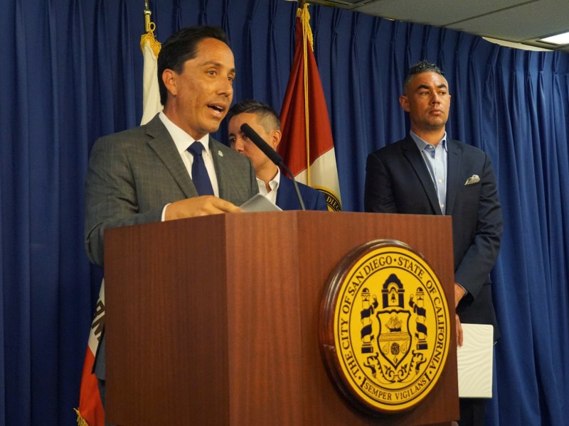 San Diego Mayor Todd Gloria, center, was joined Monday by city staff, Council President Sean Elo-Rivera and Councilman Chris Cate at City Hall to announce there is a proposed legal settlement on the 101 Ash and Civic Center Plaza transaction battle. / Photo by Andrea Lopez-Villafana