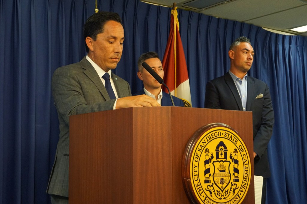 San Diego Mayor Todd Gloria, center, was joined Monday by city staff, Council President Sean Elo-Rivera and Councilman Chris Cate at City Hall to announce there is a proposed legal settlement on the 101 Ash and Civic Center Plaza transaction battle. / Photo by Andrea Lopez-Villafana