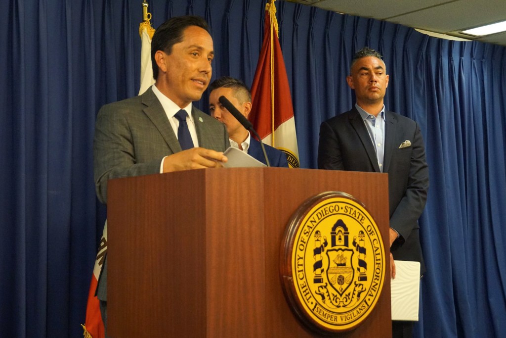 San Diego Mayor Todd Gloria, center, was joined Monday by city staff, Council President Sean Elo-Rivera and Councilman Chris Cate at City Hall to announce there is a proposed legal settlement on the 101 Ash and Civic Center Plaza transaction battle. / Photo by Andrea Lopez-Villafana