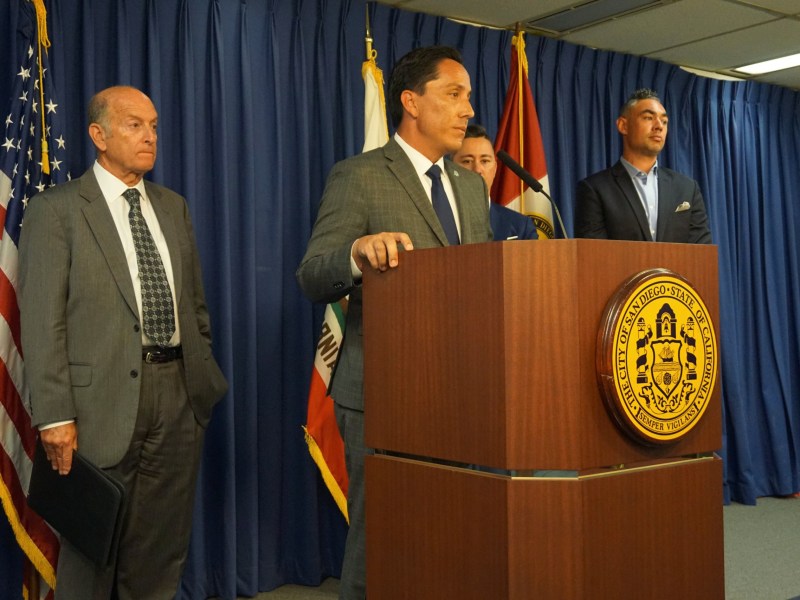 San Diego Mayor Todd Gloria, center, was joined Monday by city staff, Council President Sean Elo-Rivera and Councilman Chris Cate at City Hall to announce there is a proposed legal settlement on the 101 Ash and Civic Center Plaza transaction battle. / Photo by Andrea Lopez-Villafana