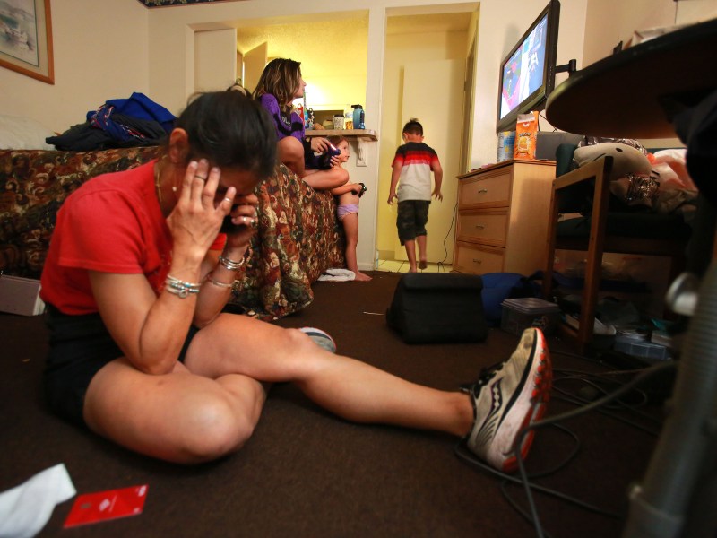 Natalie Raschke struggles to speak to a woman from the auto repair shop where their van is being repaired.