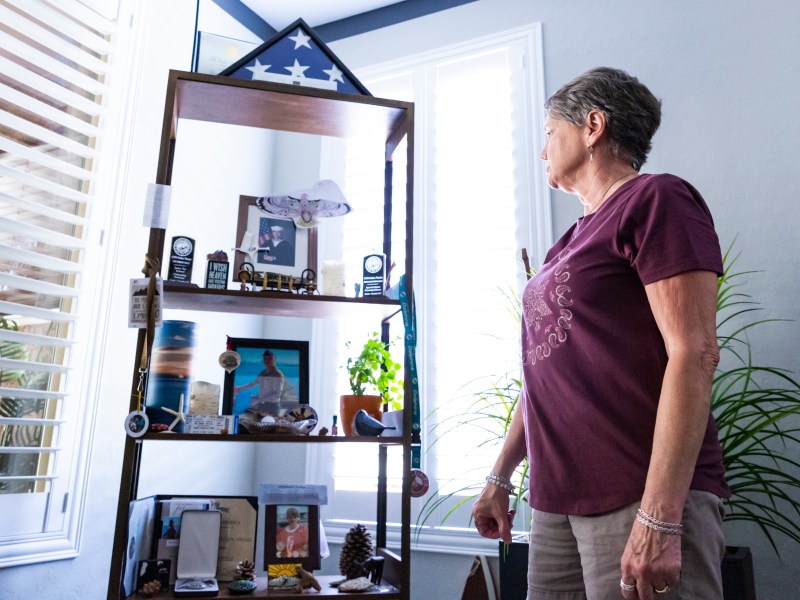 Jodee Watelet looks at a shelf dedicated to her son, Kellen Watelet, in her home in Mesquite, Nev., on Friday, May 20, 2022. / Photo by Miranda Alam for Voice of San Diego
