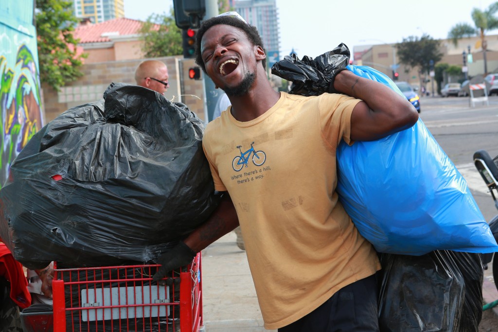 Morris Loadholt, 30, takes advantage of the Triangle Project where he can bring in bags of trash in exchange for $2 a bag, downtown near the intersection of Commercial Avenue and 16th Street on the last day of the Triangle Project's operation Thursday, June 30, 2022. / Photo by Peggy Peattie for Voice of San Diego