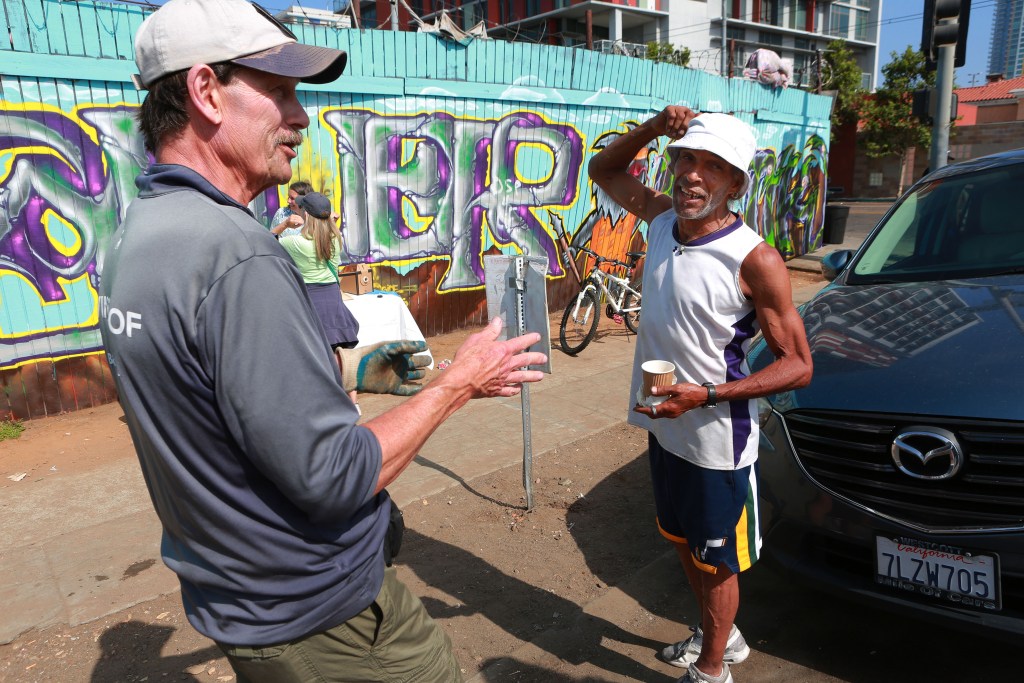 Brian Trotier, left, talks with Richard Horton, right, near the intersection of Commercial Avenue and 16th Street on the last day of the Triangle Project's operation Thursday, June 30, 2022. / Photo by Peggy Peattie for the Voice of San Diego 