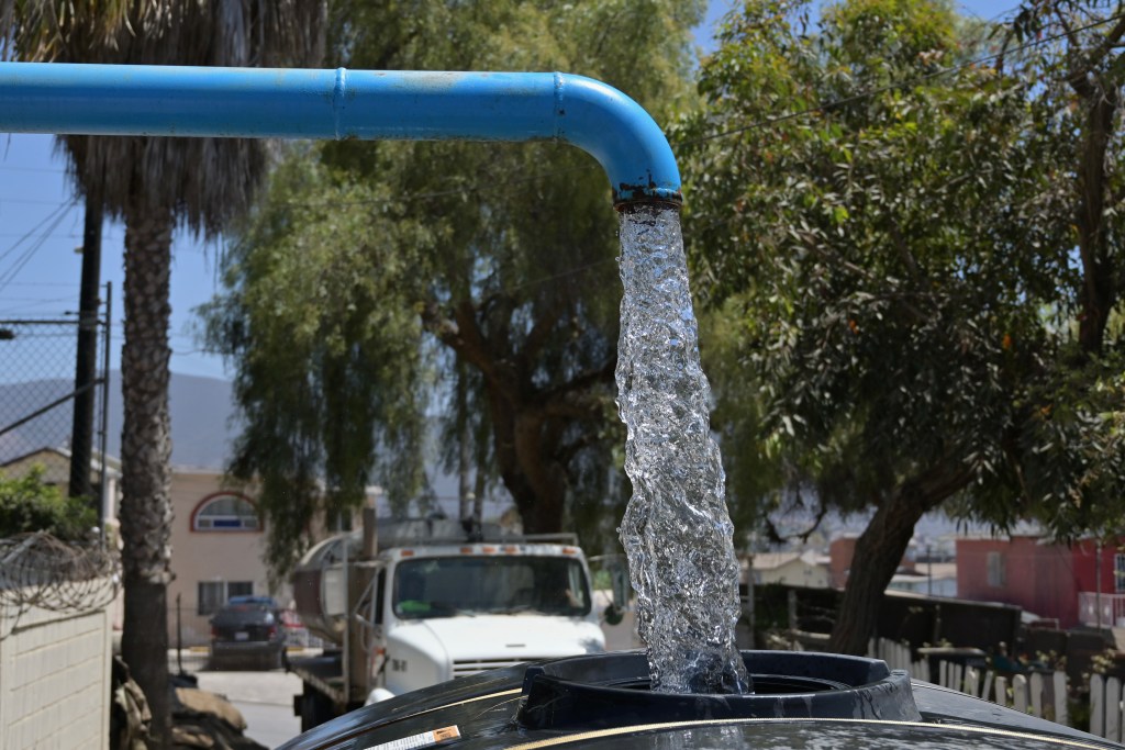 Water trucks called "pipas" are filled with water from a desalination plant in Ensenada to serve residents whose water service has been cut, sometimes for months. / Photo by Carlos A. Moreno for Voice of San Diego