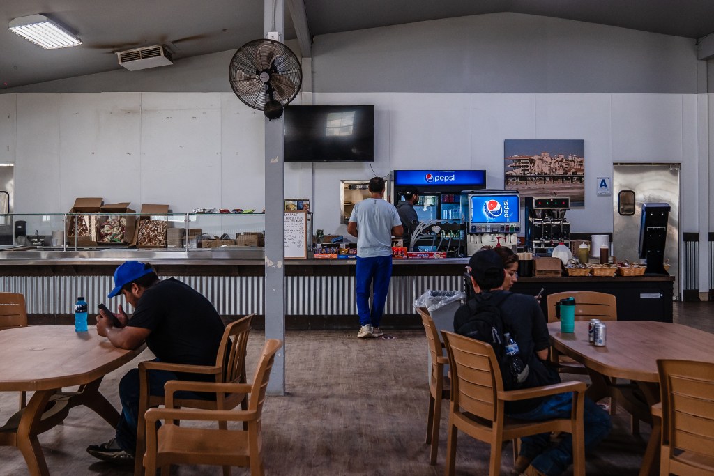 Workers on their break in the cafeteria at the Del Mar Fairgrounds on July 29, 2022.