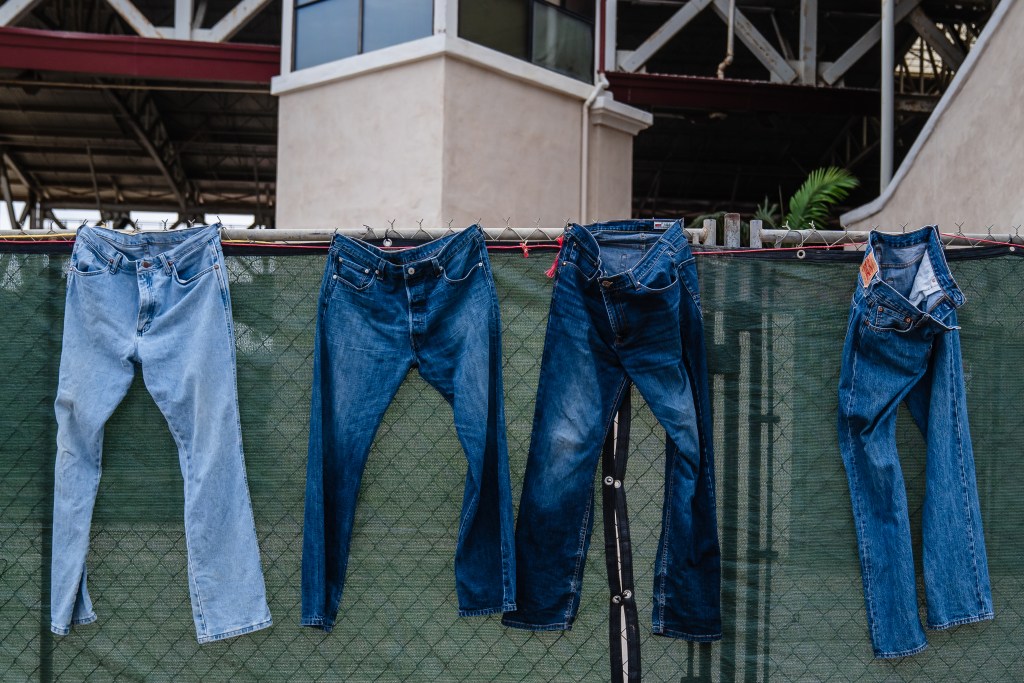 Jeans hang on a fence near where horse groomers work at the Del Mar Fairgrounds on July 29, 2022.