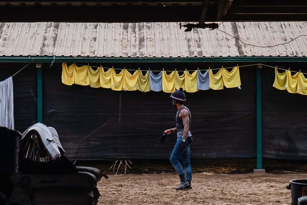 A man walks near the horse stables at the Del Mar Fairgrounds on July 29, 2022.