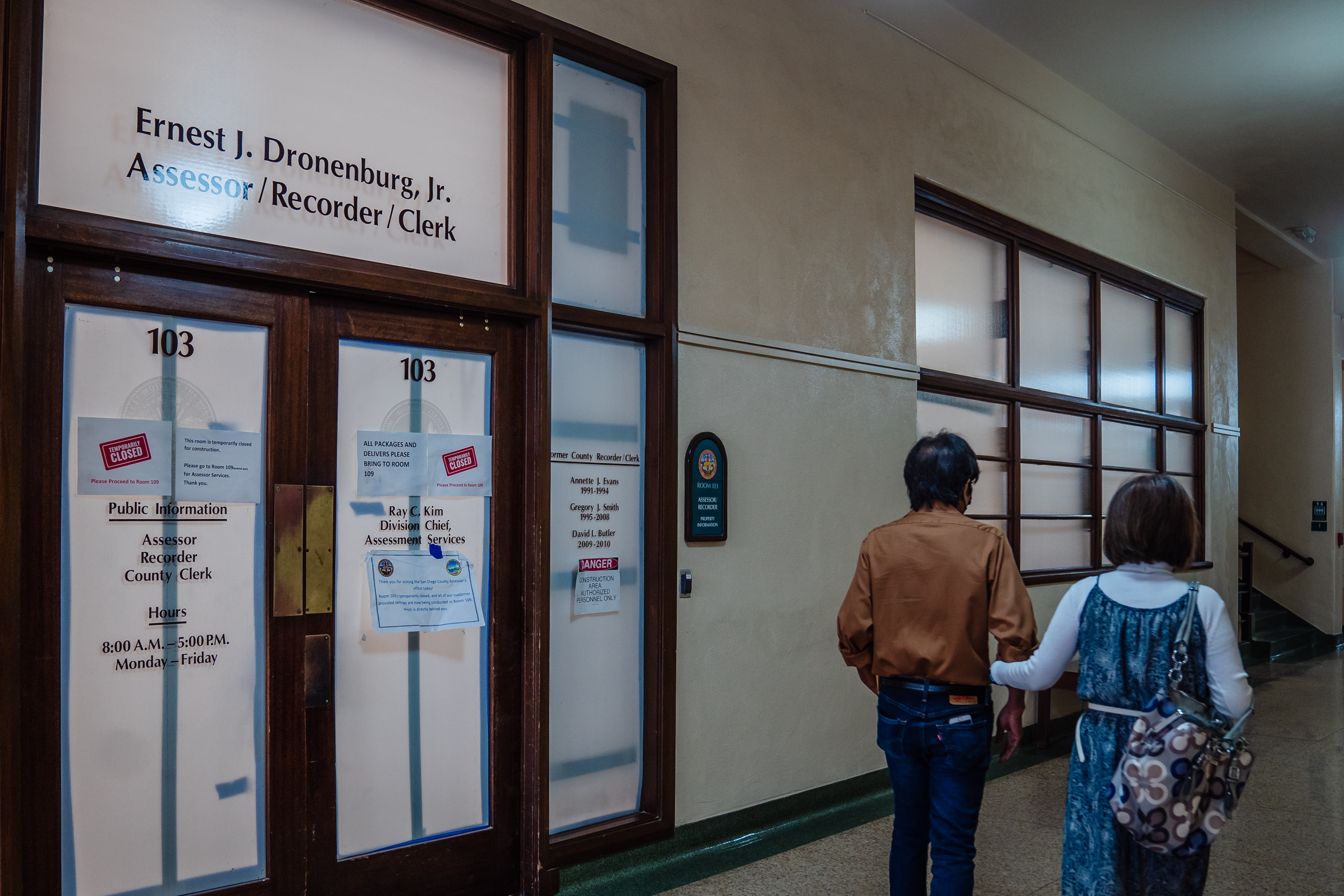 People walk passed the Ernest J. Dronenburg, Jr., Assessor/Recorder/Clerk’s office in downtown on Oct. 3, 2022.