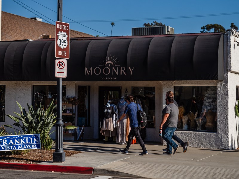 Men walk on Main Street in Vista on Oct. 18, 2022.