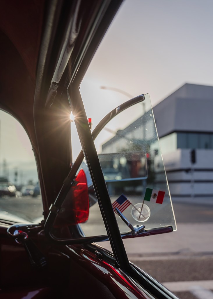 Marisa Rosales displays a small Mexican and American flags in her 1949 Hudson Commodore in National City on Oct. 7 , 2022.