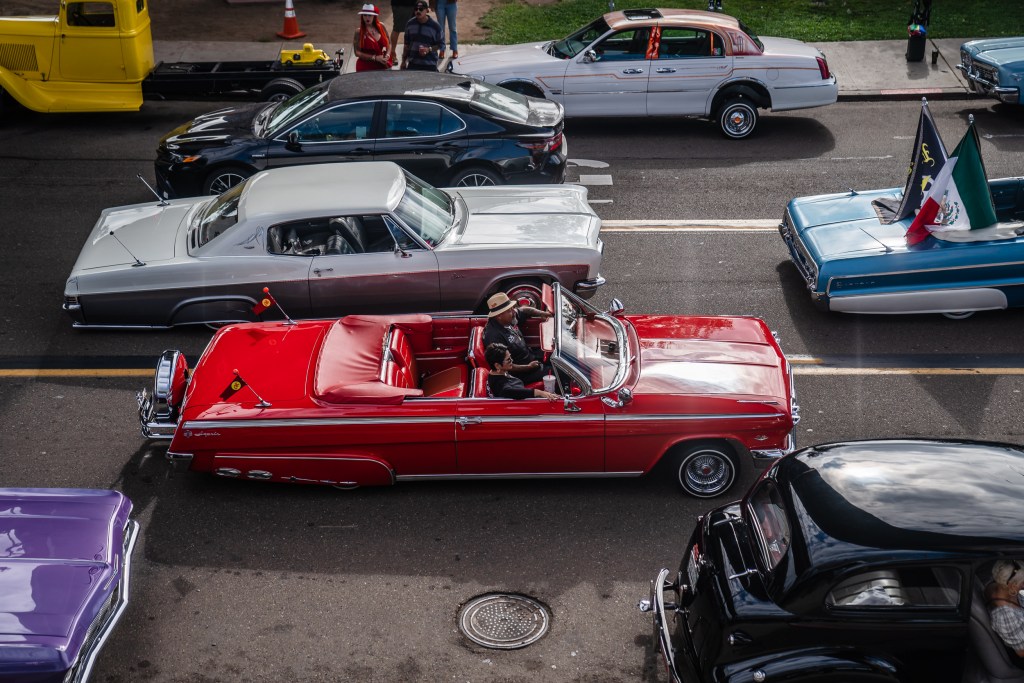 Marcos and Jovita Arellano cruise in an Impala convertible in Barrio Logan on Oct. 16, 2022.