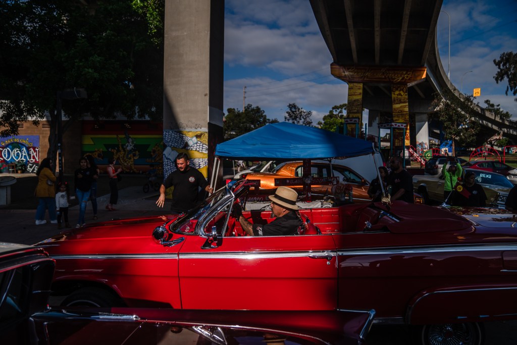Marcos Arellano in his Impala convertible at Chicano Park in Barrio Logan on Oct. 16, 2022.
