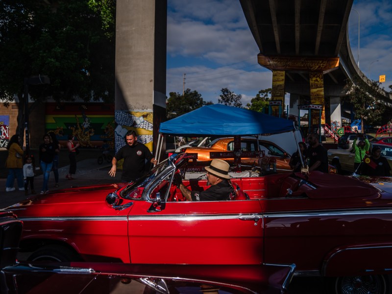 Marcos Arellano in his Impala convertible at Chicano Park in Barrio Logan on Oct. 16, 2022.