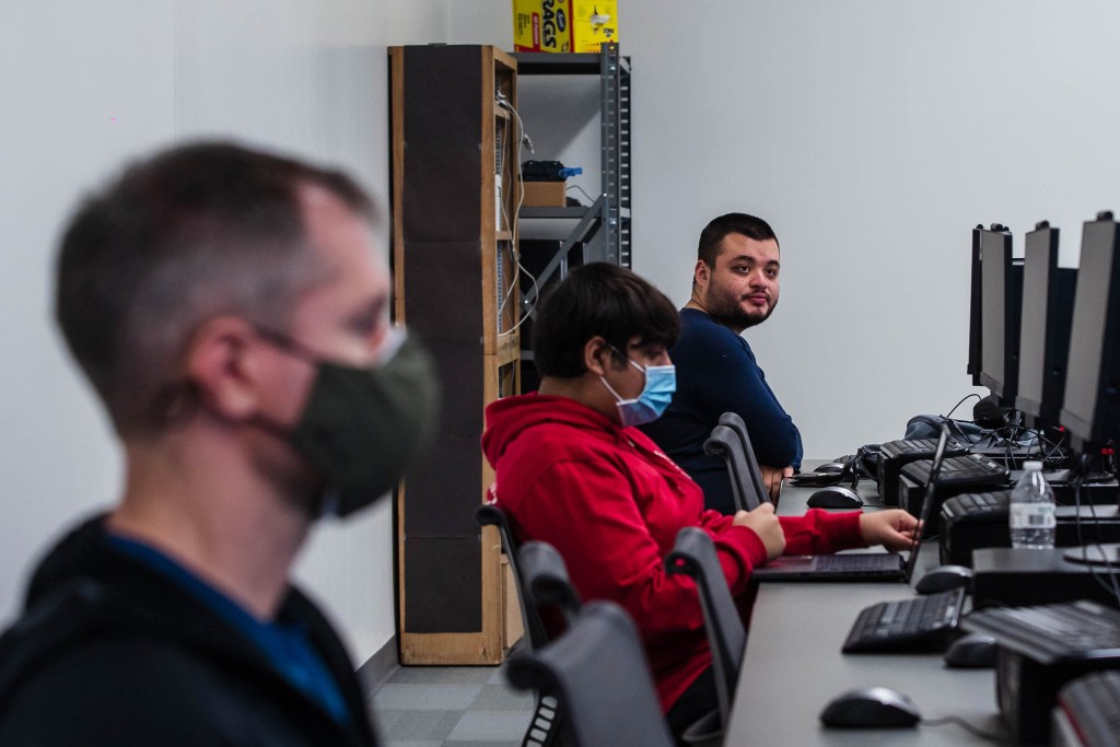 Students listen to Professor David Kennemer during a cyber security class at San Diego City College on Nov. 29, 2022.