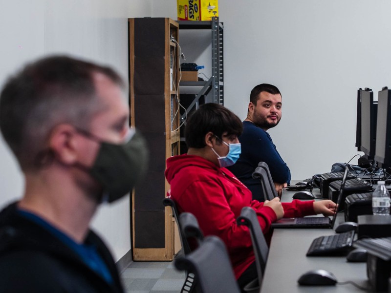 Students listen to Professor David Kennemer during a cyber security class at San Diego City College on Nov. 29, 2022.