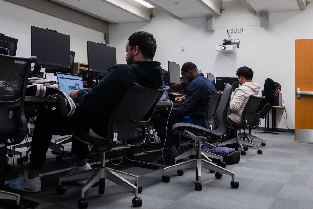 Students listen to Professor David Kennemer during a cyber security class at San Diego City College on Nov. 29, 2022.