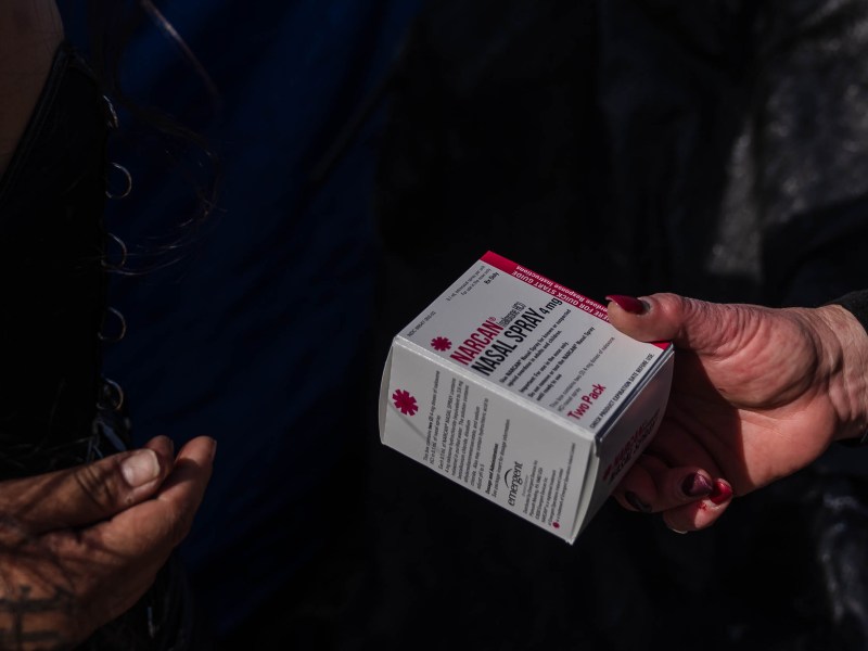 Tara Stamos-Buesig from the Harm Reduction Coalition hands out Narcan Nasal Spray to people living in a homeless encampment in downtown on Nov. 11, 2022.