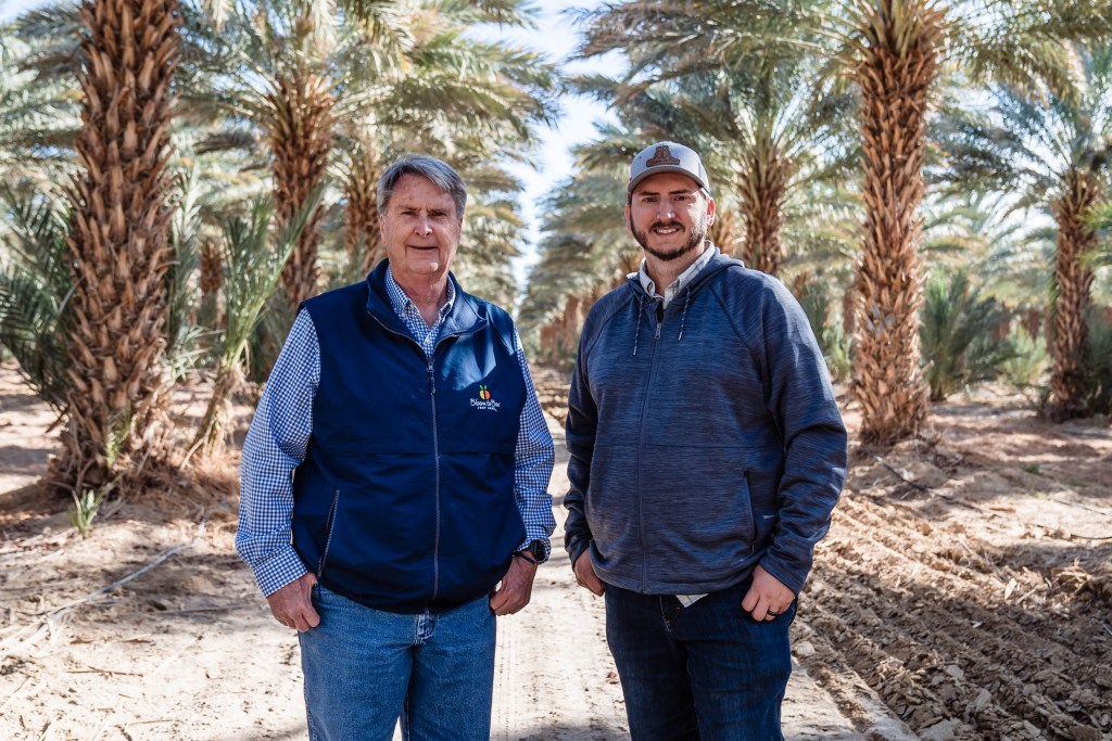Mark McBroom (left) and his son Marshal McBroom at the Bloom to Box citrus farm in Imperial Valley on Nov. 17, 2022.
