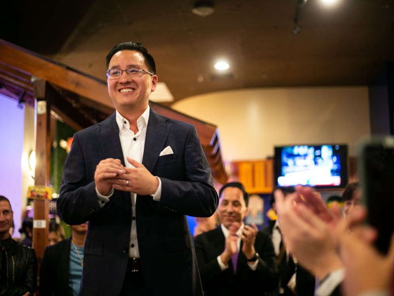 San Diego City Council candidate Kent Lee is applauded at the Crab Hut in San Diego on Nov. 8, 2022. / Photo for Brittany Cruz-Fejeran for Voice of San Diego
