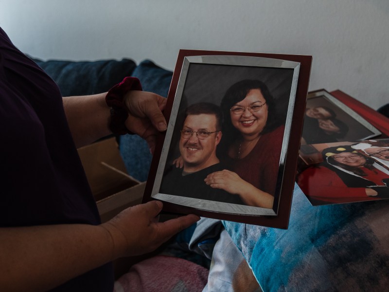 Janet Keating holds a framed photo of her and husband Patrick at her home in Lakeside on Dec. 10, 2022.
