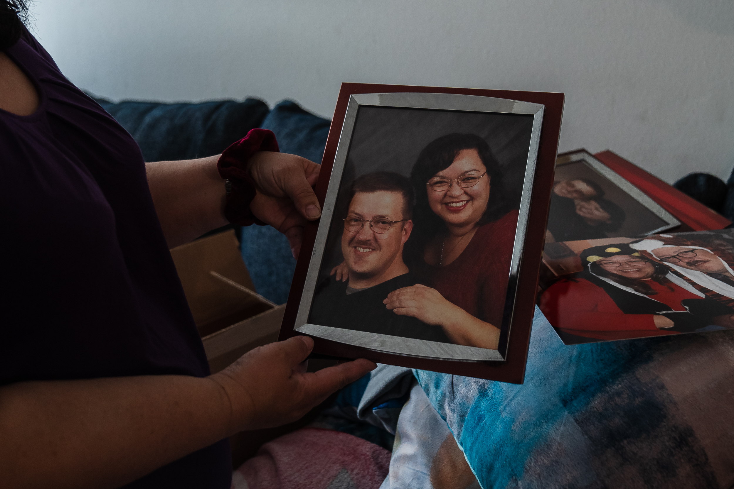 Janet Keating holds a framed photo of her and husband Patrick at her home in Lakeside on Dec. 10, 2022.