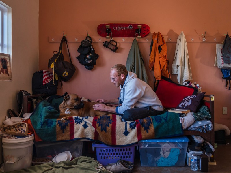 Dallin Mifflin with his dog Lita at La Posada de Guadalupe shelter in Carlsbad on Dec. 13, 2022.