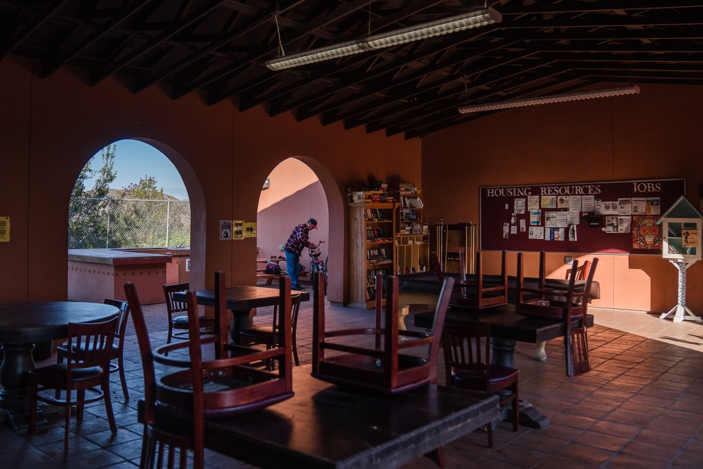 Micheal Weidekemper, 58 years old, works on his bike at La Posada de Guadalupe shelter in Carlsbad on Dec. 13, 2022.
