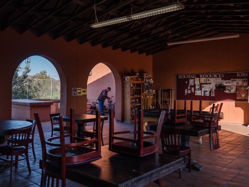 Micheal Weidekemper, 58 years old, works on his bike at La Posada de Guadalupe shelter in Carlsbad on Dec. 13, 2022.