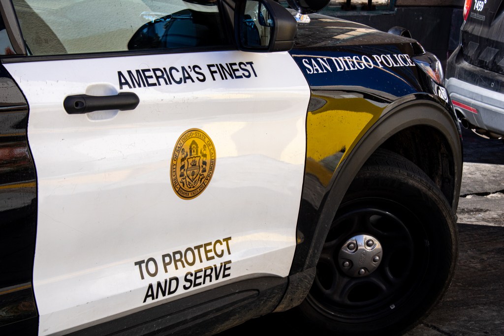 San Diego Police parked in the middle of the road to talk to a man yelling in Hillcrest on Dec. 20, 2022.