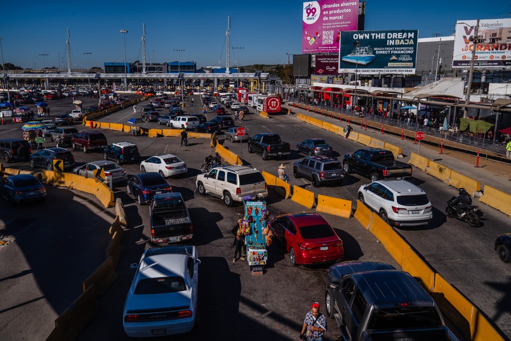 Vehicles wait in line at the Mexico-Unites States border to leave Tijuana, Mexico, and enter the United States on Dec. 21, 2022.