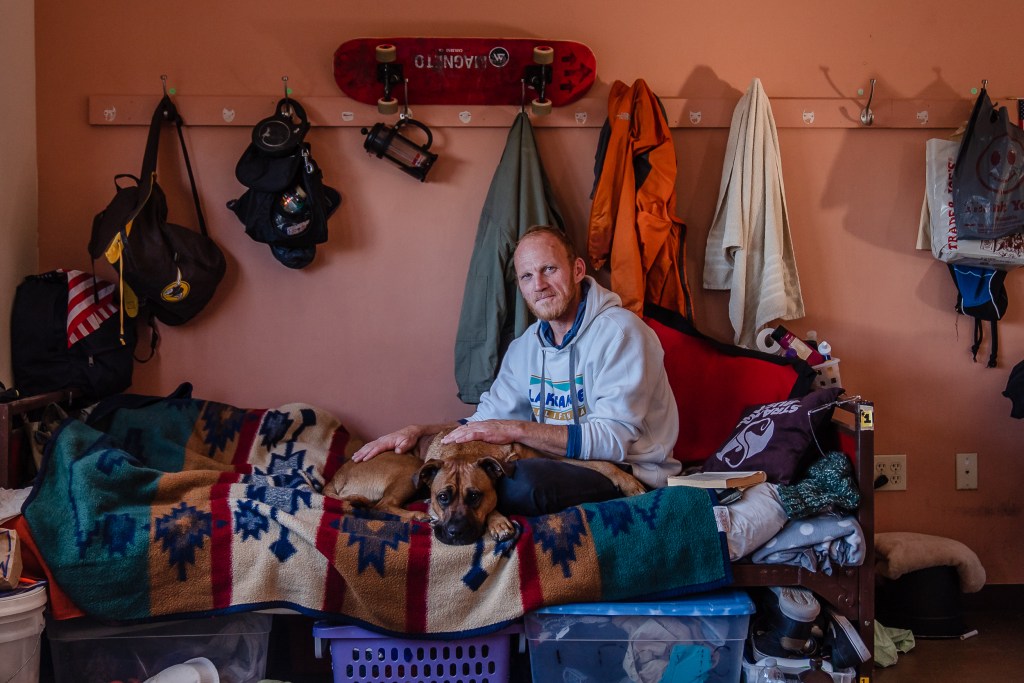 Dallin Mifflin with his dog Lita are residents of La Posada de Guadalupe shelter in Carlsbad on Dec. 13, 2022.