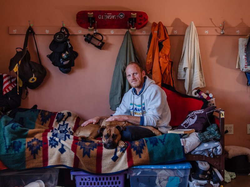 Dallin Mifflin with his dog Lita are residents of La Posada de Guadalupe shelter in Carlsbad on Dec. 13, 2022.