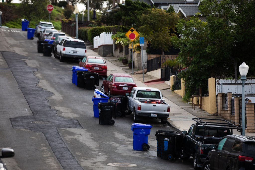 Garbage and recycle bins line a hill in the Sherman Heights neighborhood on Jan. 11, 2023.