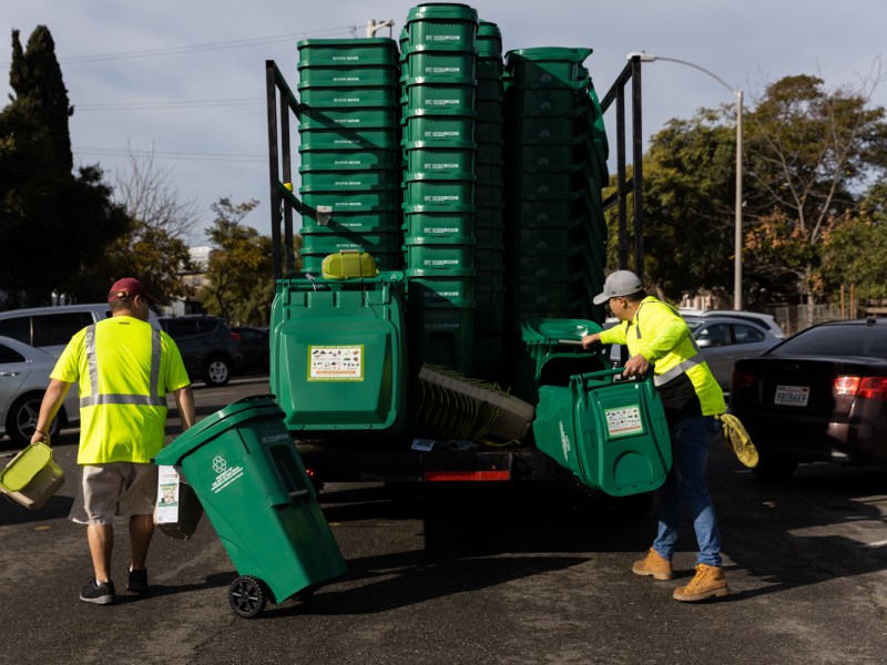 Contract workers assemble and deliver food waste bins in the Sherman Heights neighborhood on Jan. 11, 2023.