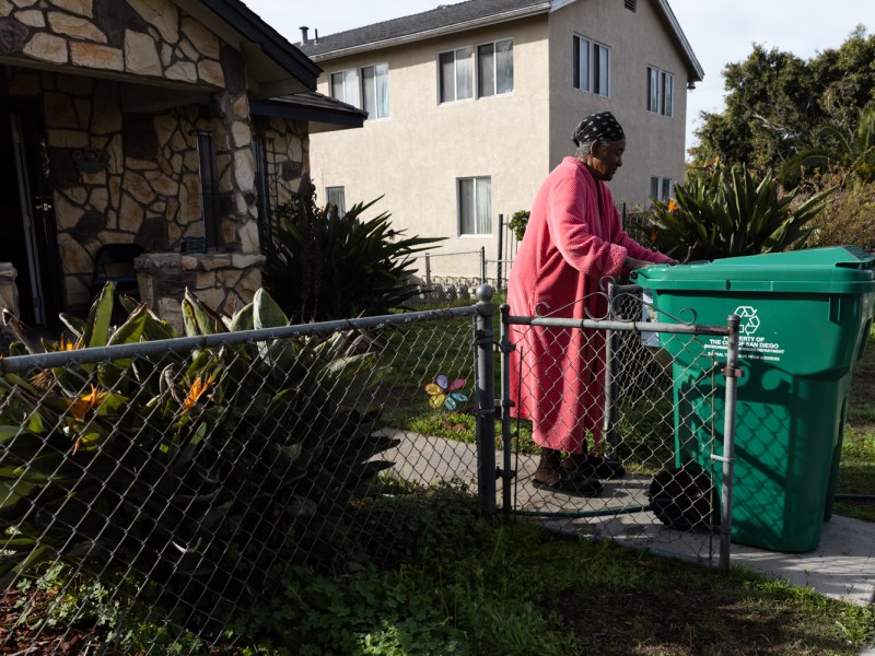 Norall Moore, who has lived in the Sherman Heights neighborhood since 1964, wheels in a new food waste bin into her front yard on Jan. 11, 2023.