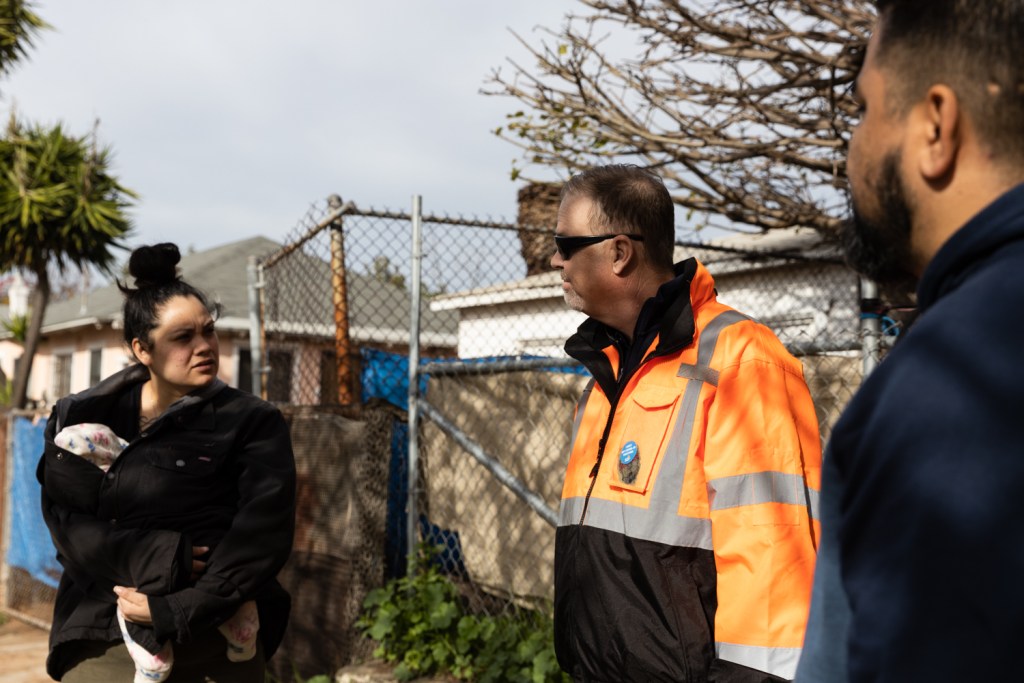 Kasandra Lopez speaks to Matthew Cleary, assistant director of the city’s environmental services department, about the new food waste bins on Jan. 11, 2023.