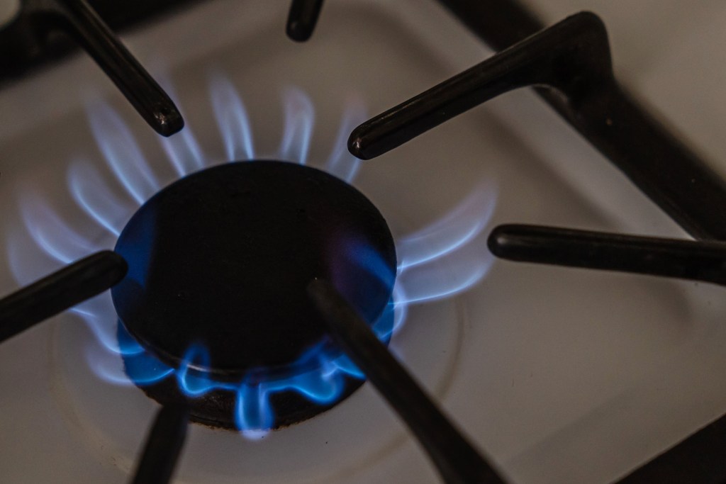 Flames burn on a gas stove on Jan. 17, 2023.