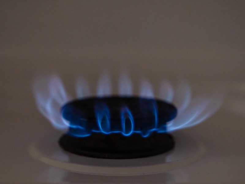 Flames burn on a gas stove on Jan. 17, 2023.