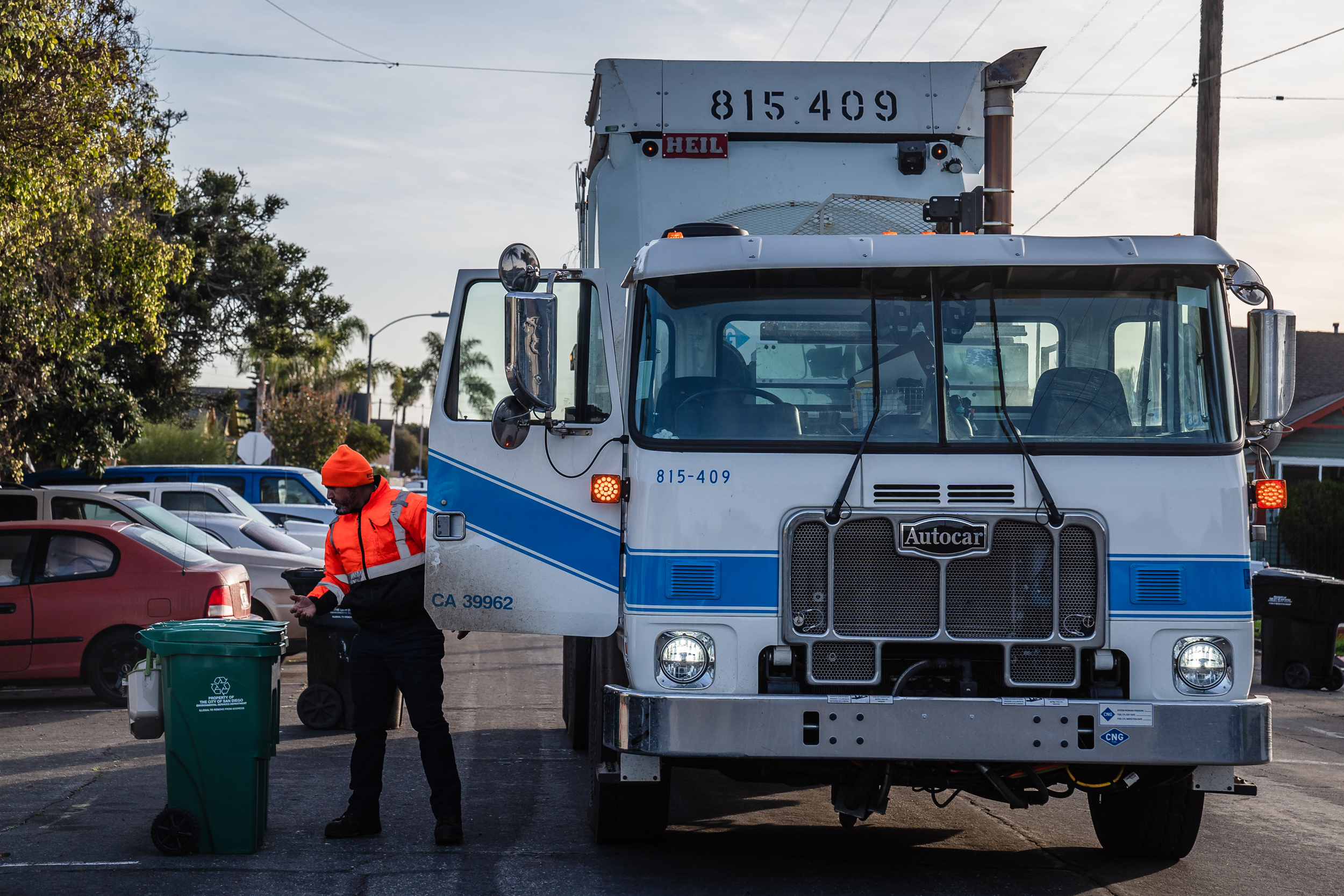 The waste collector stands in front of a new waste bin in Grant Hill on Jan. 19, 2023.