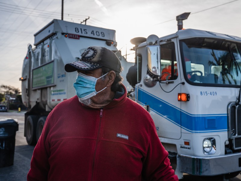 Julio Gomez stands near a garbage truck in Grant Hill on Jan. 18, 2023.