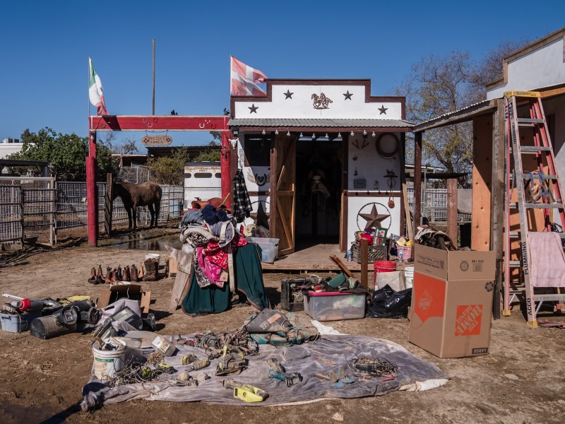 Boots, clothing, tools and other materials sit in the sun at Dresher Ranch in San Ysidro on Jan. 21, 2023.